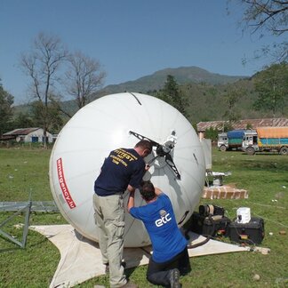 staff setting up telecom equipment